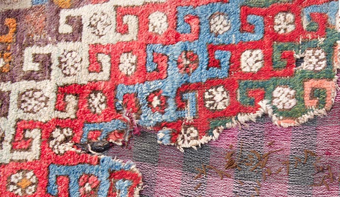 A damaged colorful rug