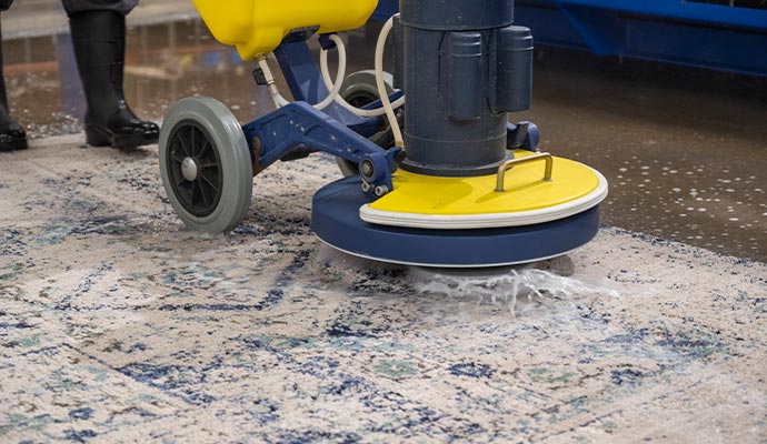 cleaning rug using commercial scrubber