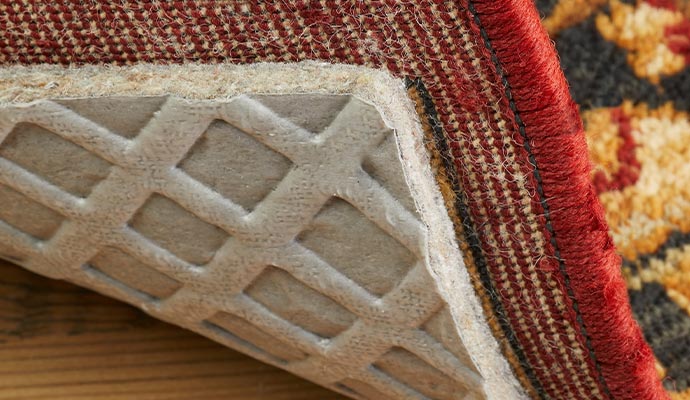 A rug showing its underside and the rug pad