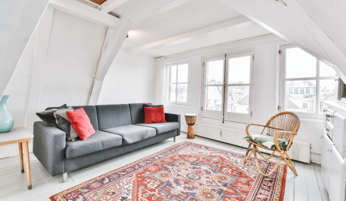 a clean living room with oriental rug on the floor