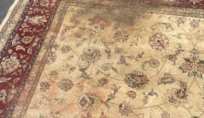 a rug that has areas of discoloration with some parts appearing faded compared to others