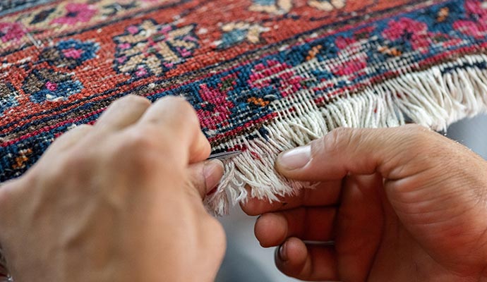 Professional repairing rug fringe.